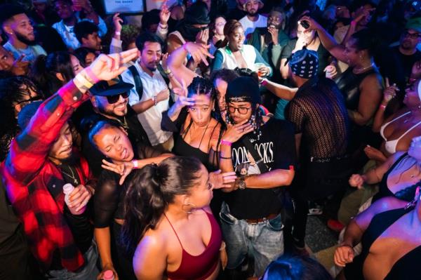 Partiers dance in the bodega.